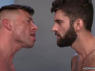 Muscular men sharing the ass of a bearded lad
